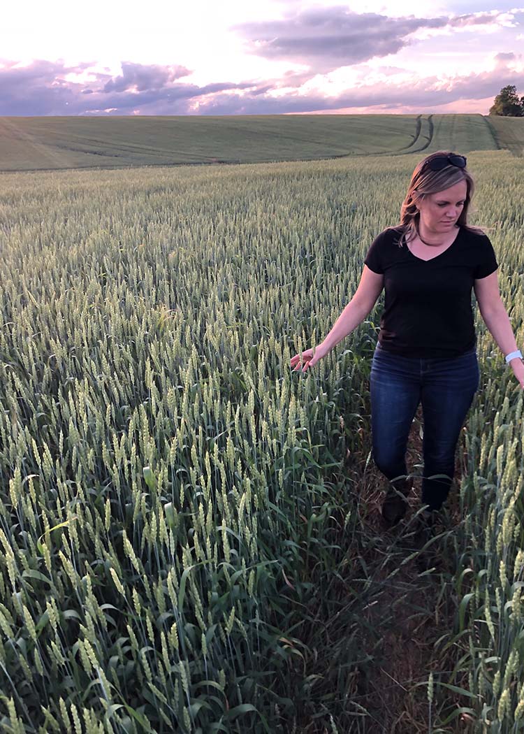Sarah from TCO walking through pasture
