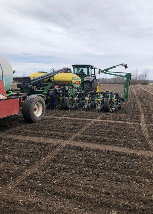 Photo of farming equipment working on crop field