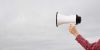 hand holding up megaphone
